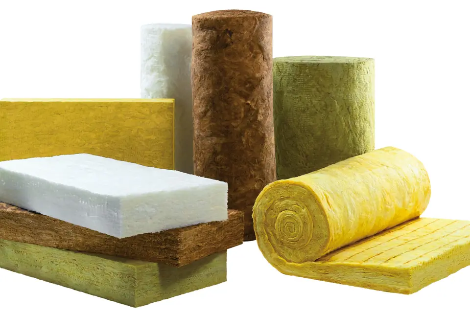 Rolls and slabs of yellow, brown, green and white mineral wool insulation arranged on a plain white background