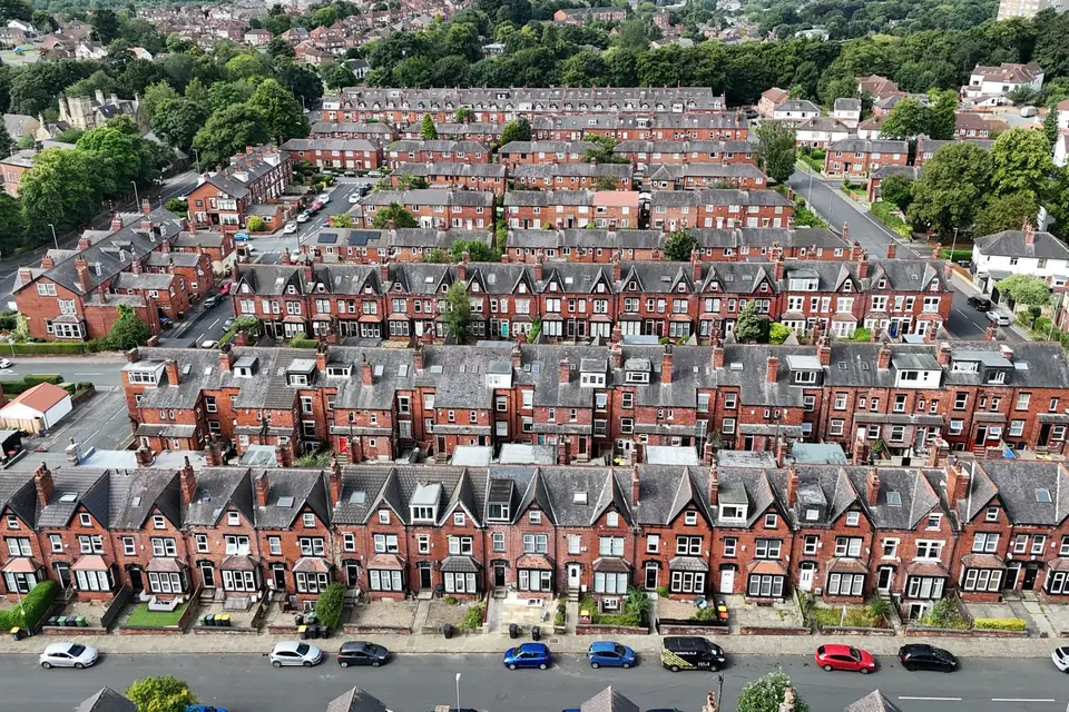 Aerial view of rows of red brick terraced houses with grey slate roofs and small front gardens in Headingley, Leeds